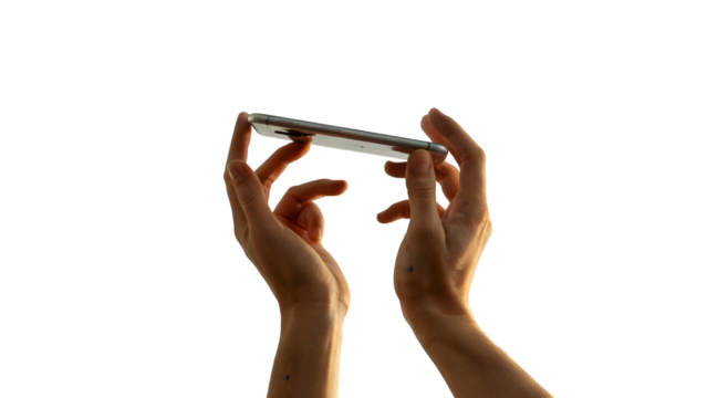 Two hands holding a silver smartphone horizontally against a dark background technology