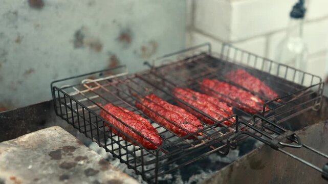 Caucasian-style lula kebabs sizzling on rustic grill over firewood