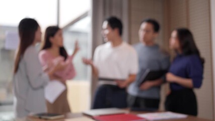 Blurred Asian adult professionals engaging dynamic business discussion collaboration blurred office workspace strategic planning innovation - Powered by Adobe