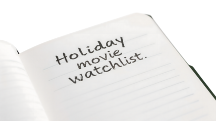 Holiday movie watchlist in open notebook: perfect for seasonal binge planning