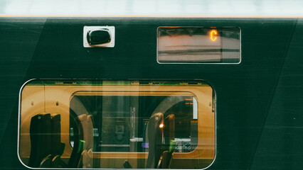 Green colored train engine on rails in city landscape, modern transport scene