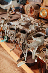 Collection of Vintage Meat Grinders on Rustic Wooden Shelf