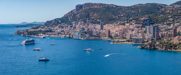 aerial landscape view of Mediterranean coastline of Monaco - officially the Principality of Monaco - located on French Riviera with skyline and skyscraper as well yachts and cruise ships near coast 