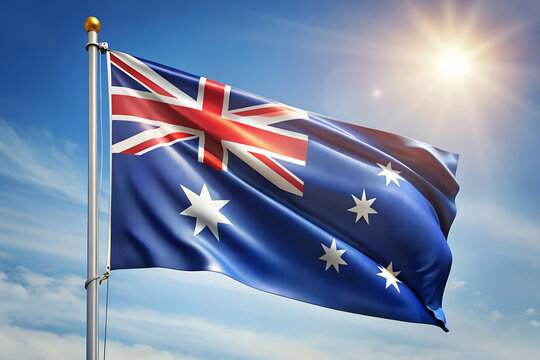 The australian flag flutters proudly against a clear blue sky