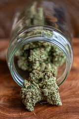 Glass jar with dried cannabis marijuana buds