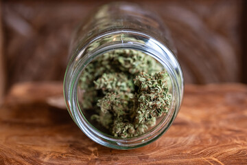 Homegrown dried cannabis marijuana buds in a glass jar