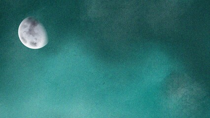 A serene gibbous moon shines brightly against a vast, textured teal sky, creating a dreamy and mystical celestial scene.