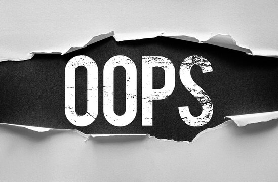 The word "OOPS" in bold, distressed white letters is dramatically revealed beneath torn paper on a dark background. Symbolic image for mistakes, accidents, or unexpected errors and apologies