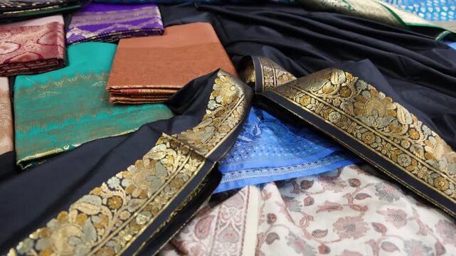traditional banarasi silk sarees displayed under indoor lighting