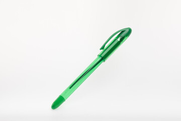 A single green ballpoint pen. It features a translucent green barrel, a matching