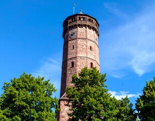 Tower amidst trees against a clear sky