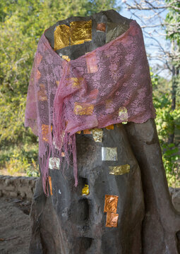 Decapitated statue with gold leaves, Mrauk u, Myanmar