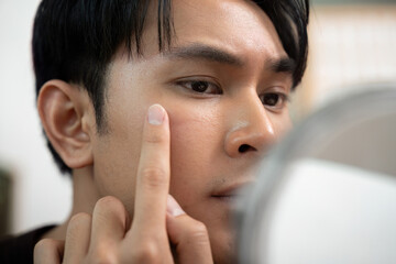 Skincare Focus: Young Man Examining Skin in Mirror