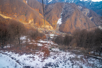 view of the valley below with a bit of snow and orange mountains