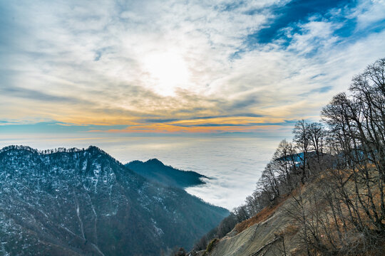 Mountain top view with the valley covered with clouds at sunset
