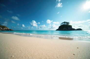 Obraz premium A sunny beach scene with clear blue sky, gentle waves, and an island in the distance