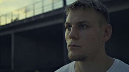 Silhouetted hand reaching toward a vibrant sunset, symbolizing achievement and endurance. Captures perseverance and joy in outdoor sports, with distant mountains enhancing accomplishment.