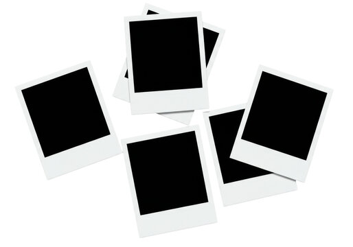 Fototapeta Blank instant camera photo frames, Polaroid-style, white borders, black inner areas, overlapping on seamless brilliant white background with copy space, clean studio lighting, top-down,