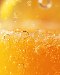 Close-up of refreshing orange soda with bubbles and vibrant color, perfect for summer drinks and beverage promotions.