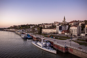 Fototapeta premium Belgrade, Serbia. A bridge over the Danube River. The city’s waterfront at sunset.