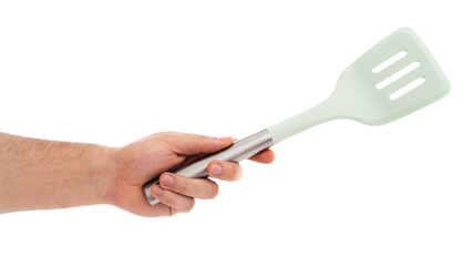 Hand with green spatula, steel handle