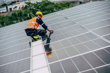 Worker performs maintenance on solar panels in a city rooftop installation during daylight hours