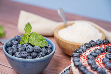 Sunset in the countryside with a bowl of blueberries and a cold berry juice, a relaxing and appetizing scene