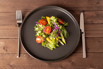 Salad on a plate.Captured from a top-down perspective, this image showcases 