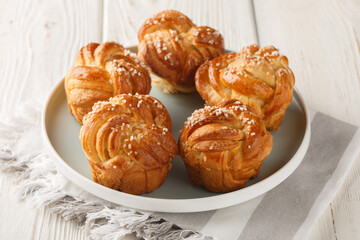 Homemade Knot sugar buns close-up in plate on table. horizontal