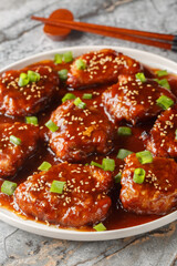 Asian style sweet and sour pork chops close-up in a plate on the table. Vertical