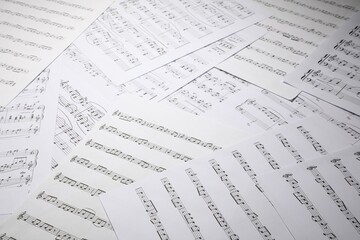 Fototapeta premium Sheets with musical notes as background, closeup