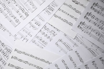 Sheets with musical notes as background, closeup