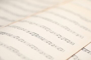 Sheets with musical notes as background, closeup