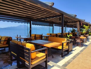 Beautiful horizontal photography concept image picture of a restaurant with tables by the sea view with blue sky golden sand sunlight summer vibes vacation palm trees wallpaper ultra high hd quality 