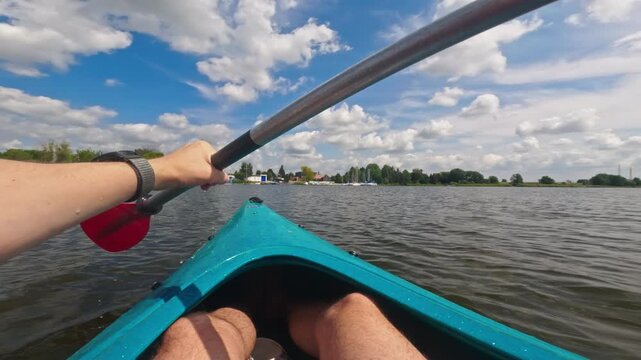 Man Canoeing On A Lake, Paddling With Oars, Enjoying Active Outdoor Water Sports