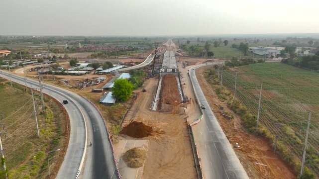 Aerial view drone footage of bridge construction being made across the intersection