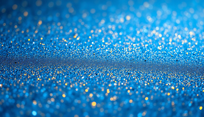 Blurred blue surface with golden glitter outoffocus creating a magical ethereal texture