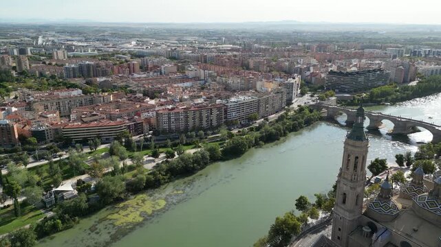 Aerial view of the Basilica del Pilar and stone bridge across the Ebro River with the city sprawling into the horizon, Zaragoza, Aragon, Spain.