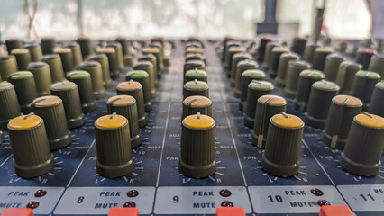Close-up of audio mixer faders in recording studio, electronic equipment for sound systems.