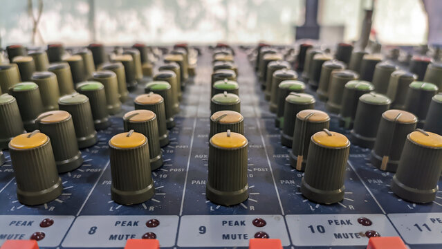 Close-up of audio mixer faders in recording studio, electronic equipment for sound systems.