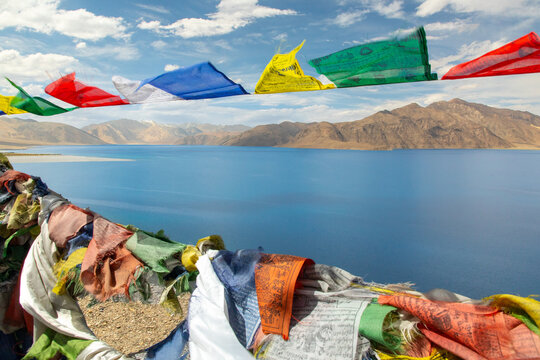 Peaceful view of Pangong Tso with prayer flags