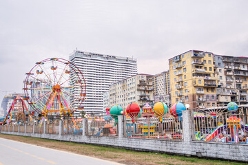 Colorful ferris wheel and rides in batumi amusement park