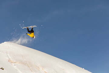 Snowboarder performing a freeride trick in powder snow