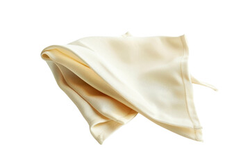 Naklejka premium Soft cream-colored fabric draped elegantly on a surface with natural light illuminating its texture and folds