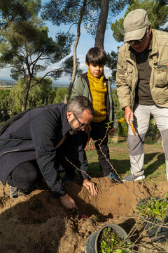 Family replanting together in a local urban park