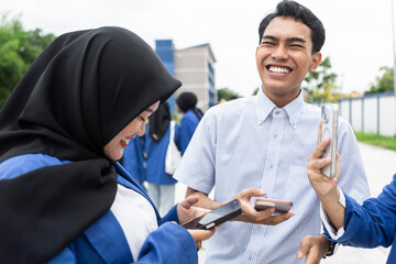 Asian students sharing a joyful moment on campus