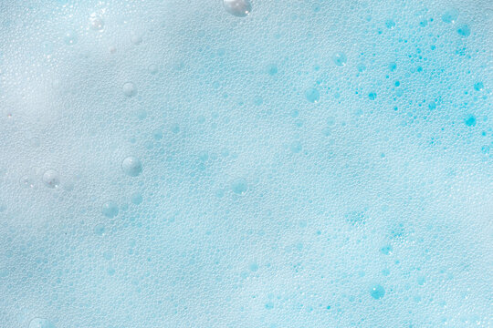 Blue foam texture with delicate bubbles close-up