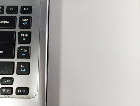 Partial View of Grey Laptop Keyboard on White Background