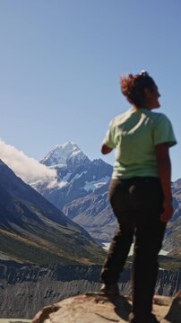 Spectacular view of Mt. Cook with hiker in foreground