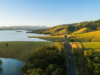 car traveling down country road beside lake in Hunter Valley NSW Australia